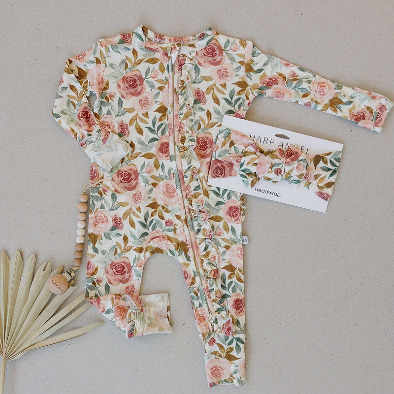 Dusty pink floral ruffle zipper one piece with 2-way zipper and fold over cuffs.