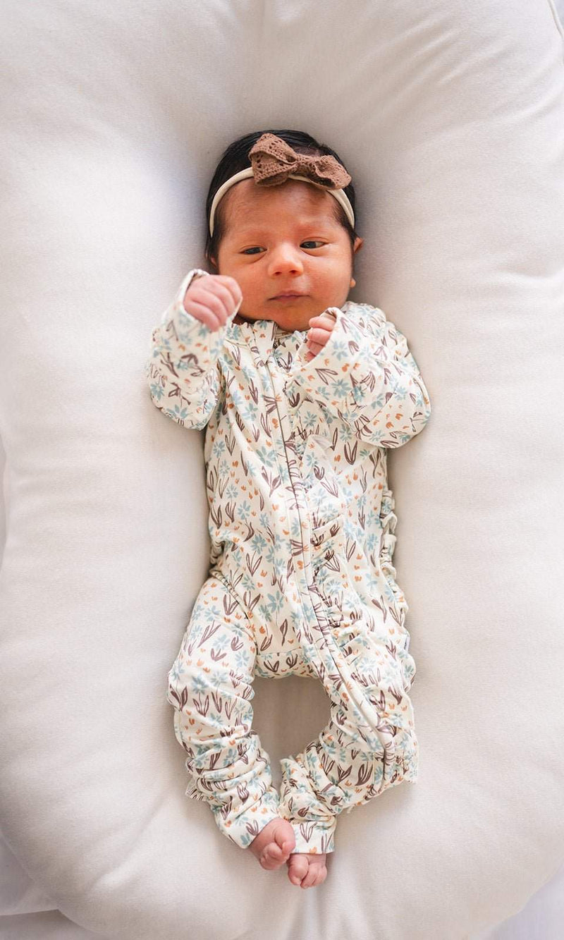 Ruffle Zipper One Piece baby pajamas in La La Floral design with ruffle details and 2-way zipper closure.