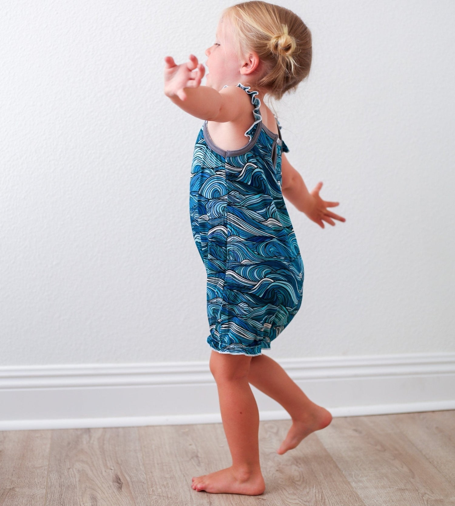 Sleeveless bubble romper with flutter sleeves in a Sea Dreams print