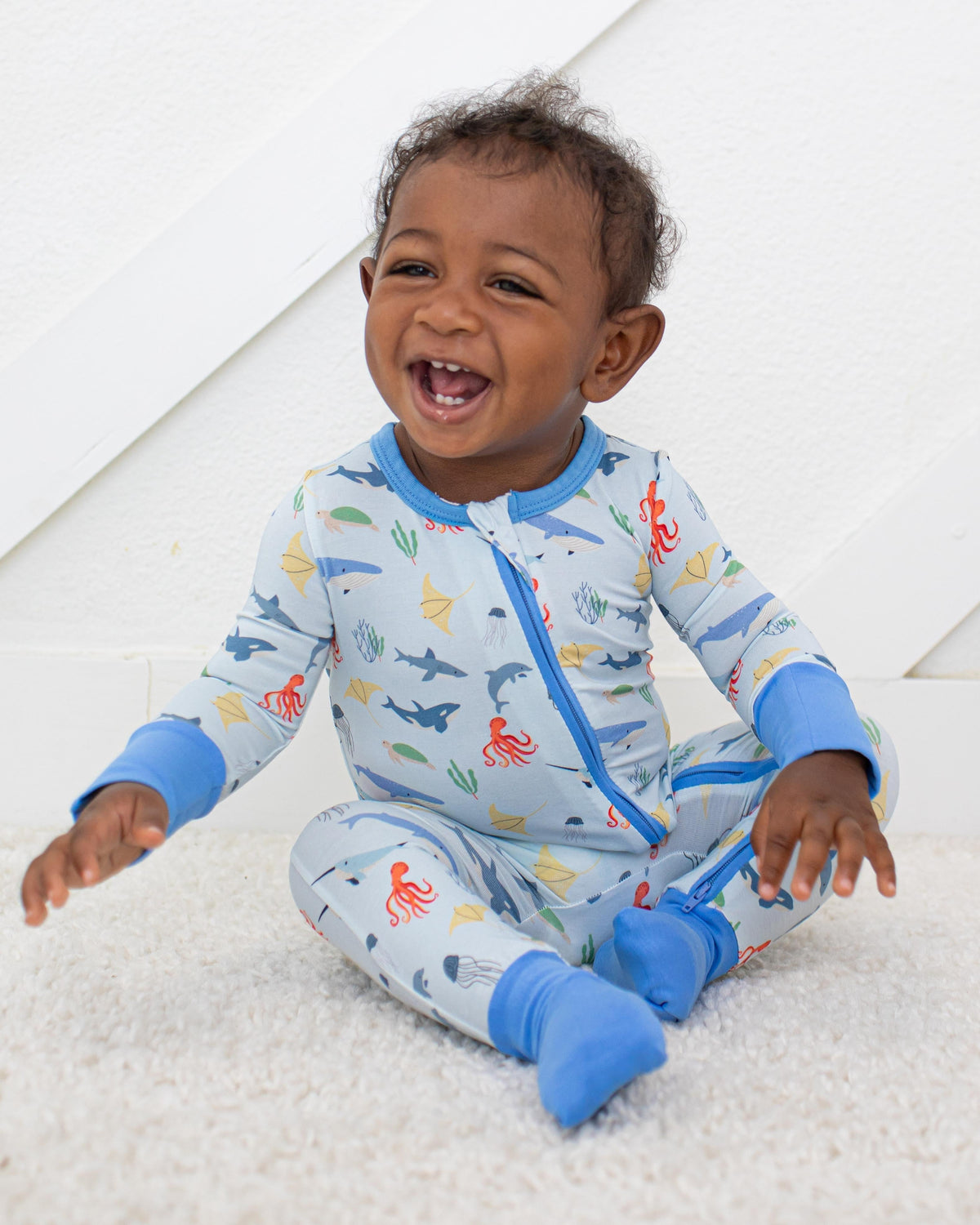 Baby convertible coverall in a sea life print with two-way zipper and convertible feet