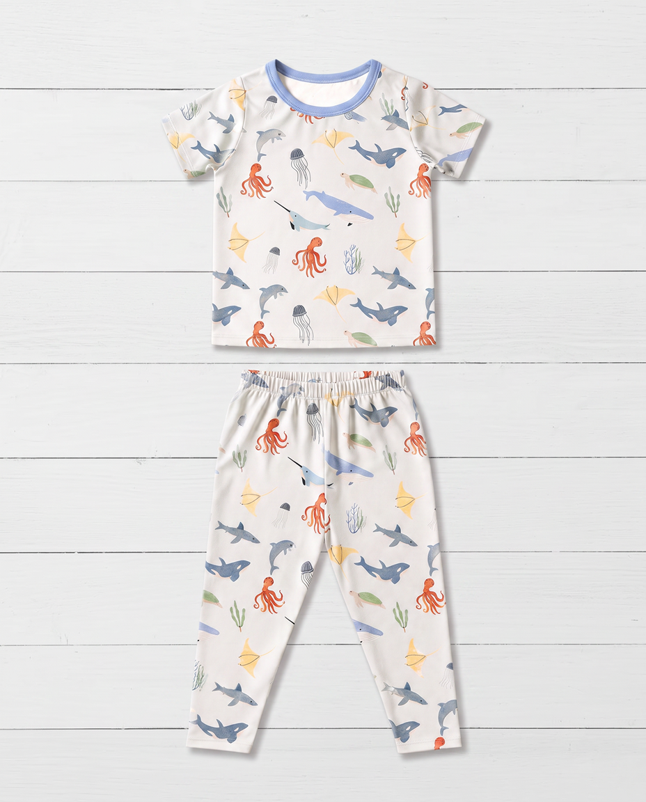 Two-piece pajama set with short sleeve top and long pants in a sea life print
