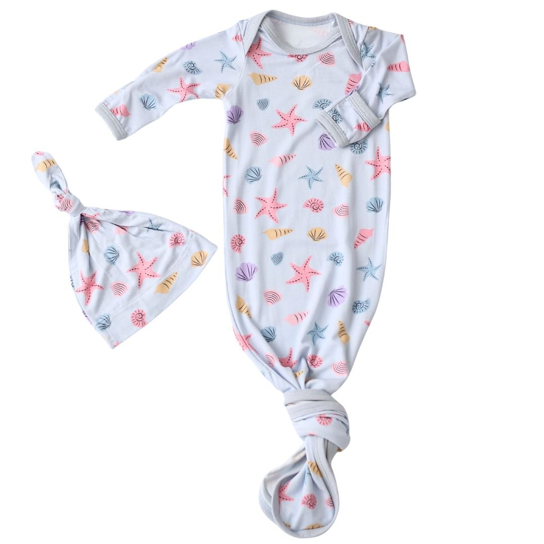 Baby gown and matching hat in a seashell print, with fold-over mittens and a knotted bottom