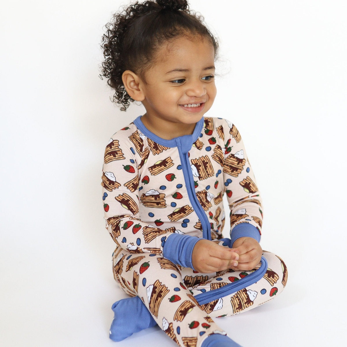 Baby zip romper in a pancake print with blueberries and strawberries, with fold-over feet.