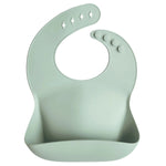 Mushie Silicone Baby Bib with Adjustable Neck Strap and Front Pocket for Easy Cleaning - 