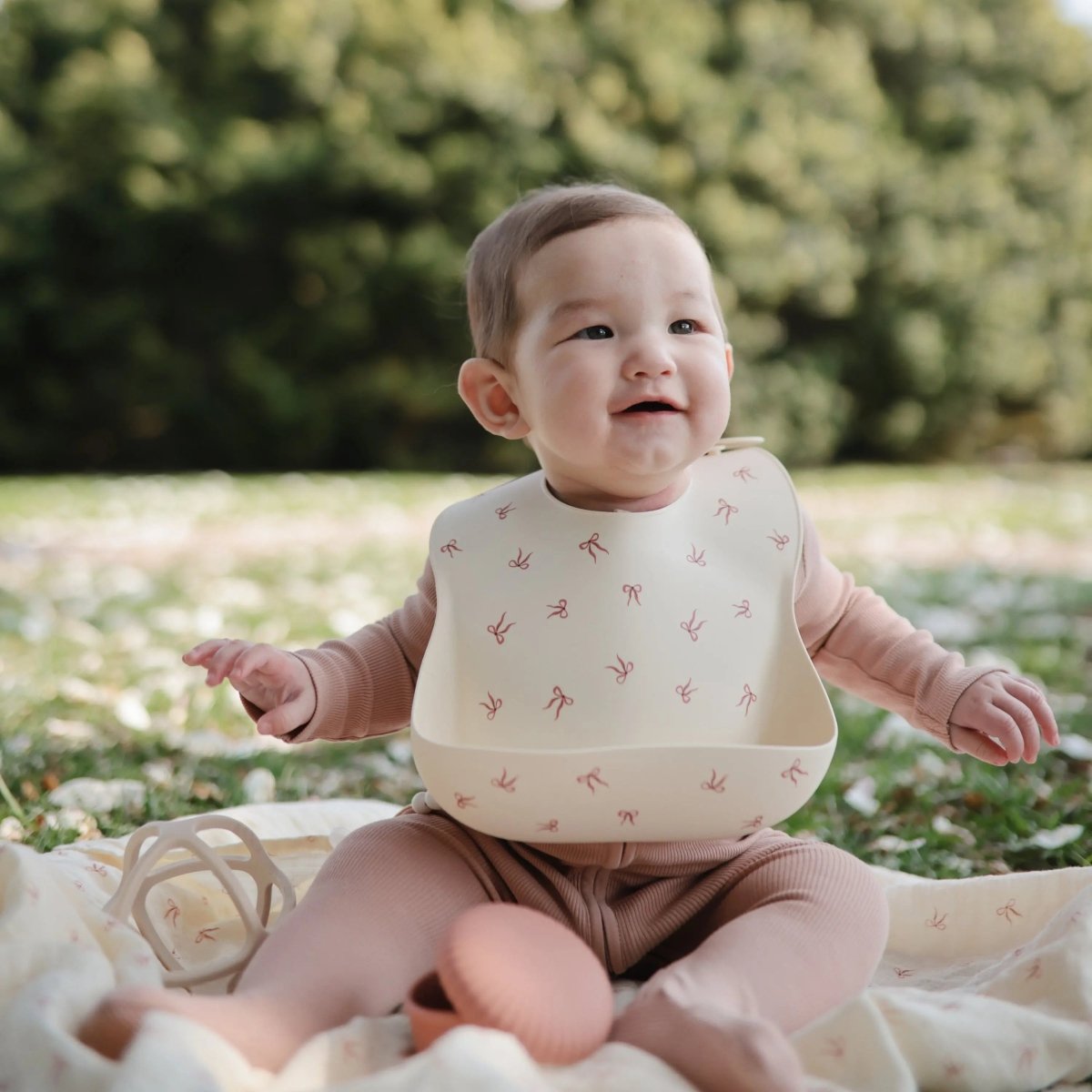 Mushie Silicone Baby Bib with Adjustable Neck Strap and Front Pocket for Easy Cleaning - 