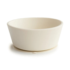 Silicone baby bowl with a suction base for staying put on the table during feeding.