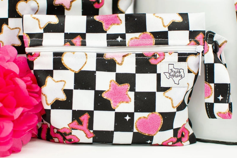 Mini Wet Bag with black and white checkered pattern, pink hearts and stars, 6x7 inches, ideal for snacks or small items.