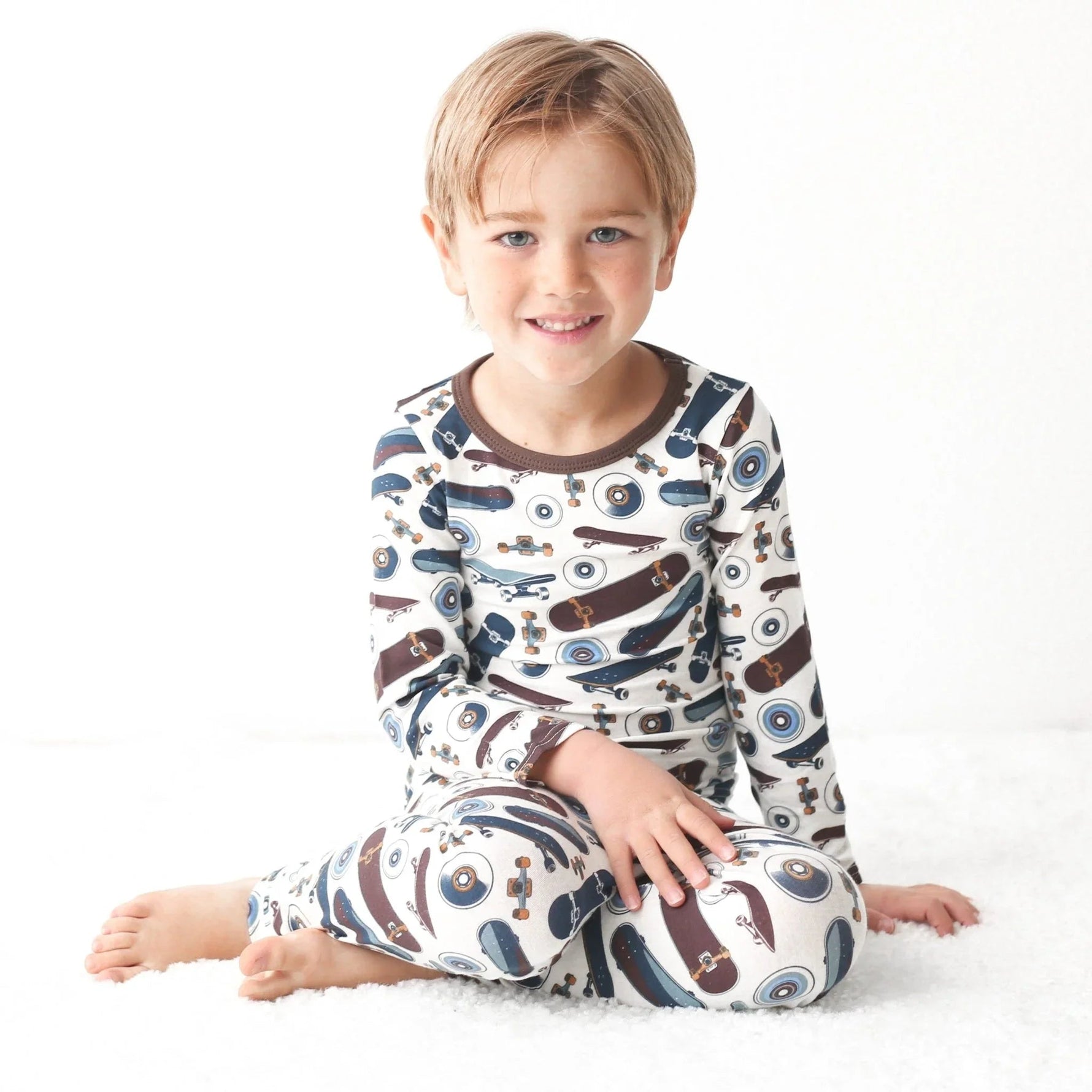 Two-piece toddler pajama set with skateboard print, long-sleeve top and matching pants