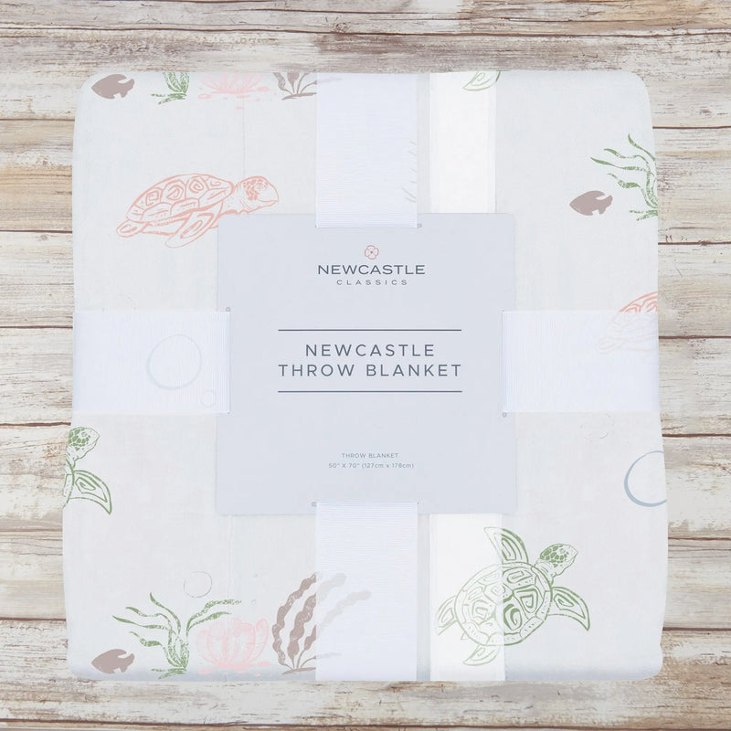 Turtles Bamboo Muslin Throw Blanket in package with turtle pattern design.