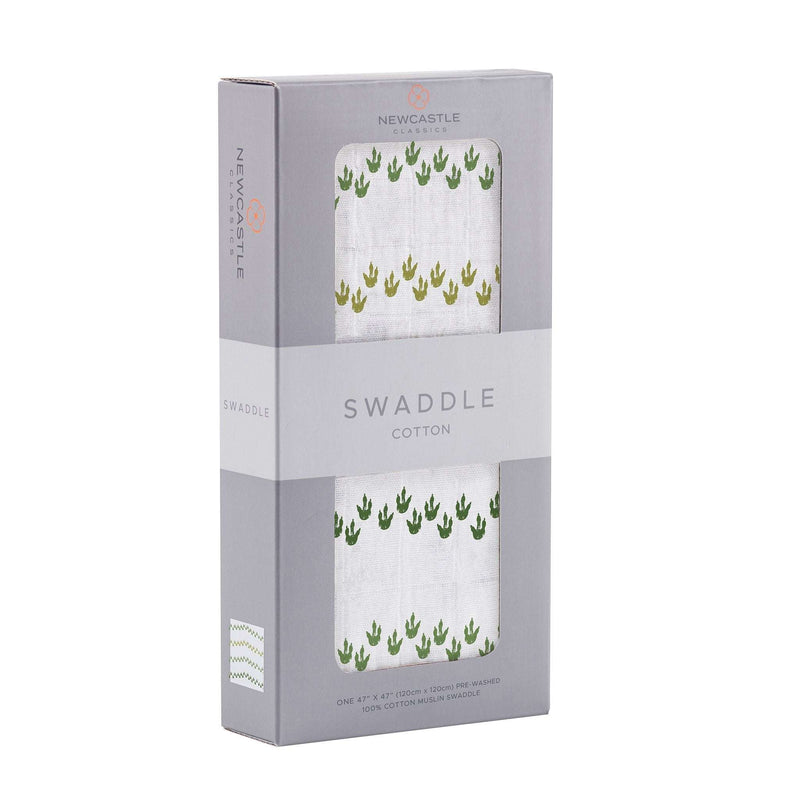 Dino Feet Cotton Muslin Swaddle in packaging, soft breathable 100% natural cotton.