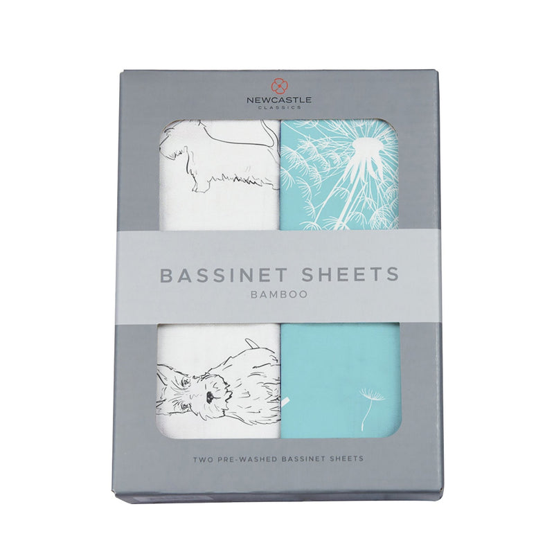 Corgi and dandelion seeds bamboo bassinet sheets in packaging.