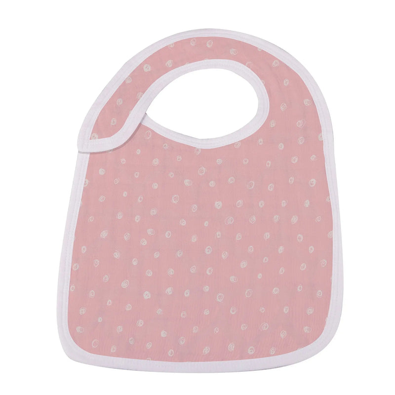 Soft bamboo muslin snap bib with pink polka dots, designed for feeding and teething.