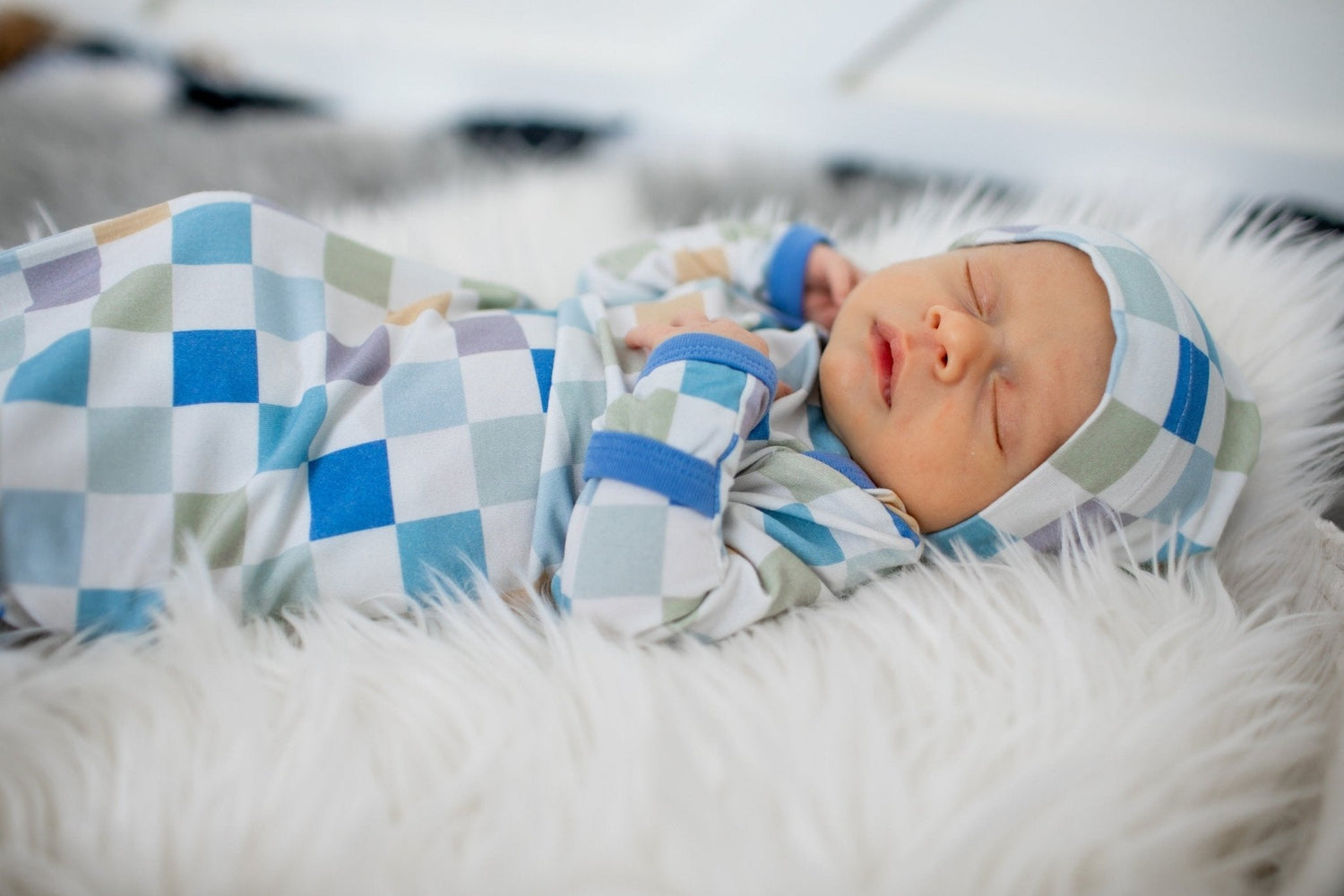 Baby knot gown and matching hat in a light checked pattern with fold-over hand mittens.