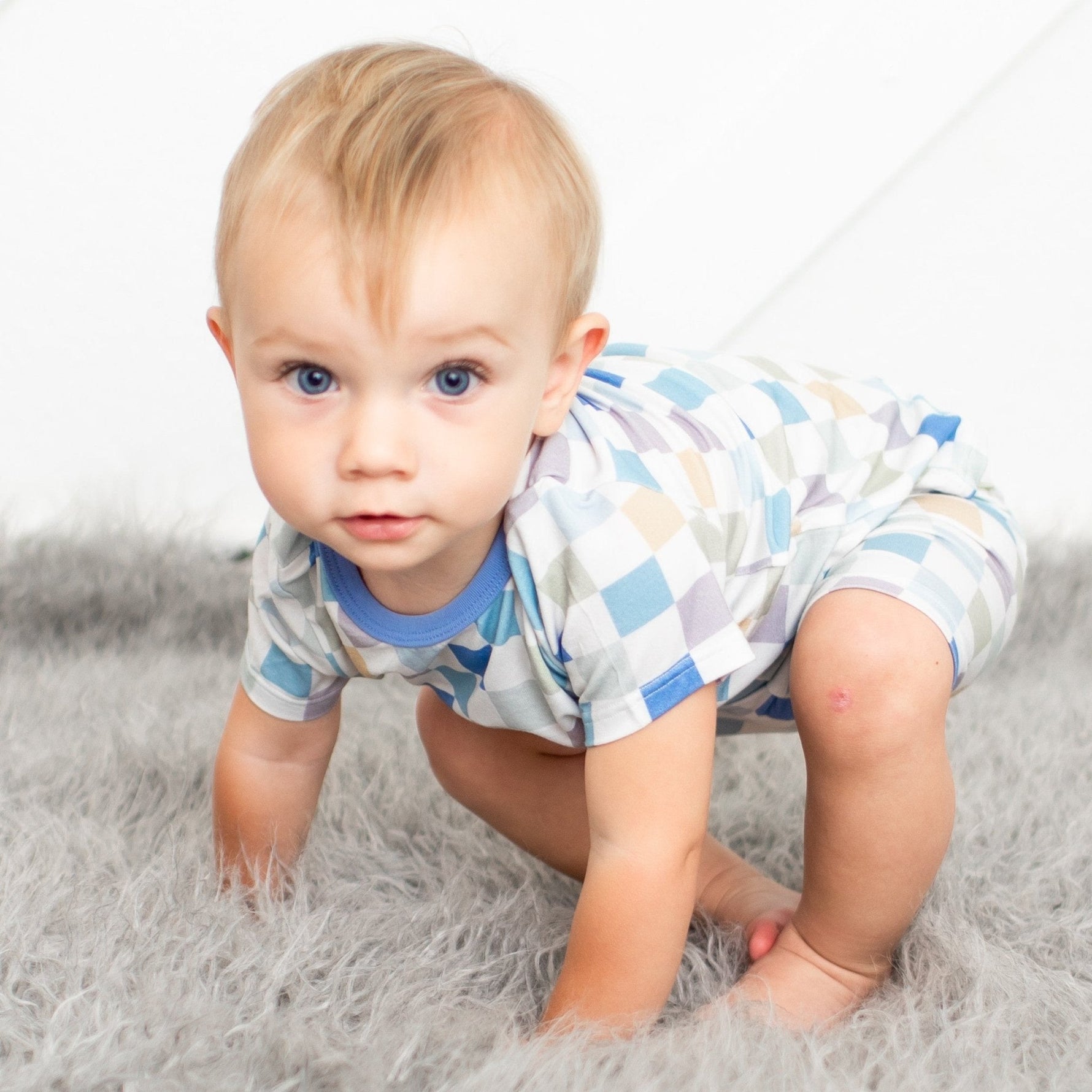 Toddler two-piece pajama set with short sleeves and shorts in a checked pattern