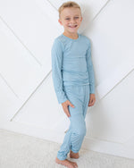 Two-piece long sleeve baby pajama set in solid Skye color with matching top and pants