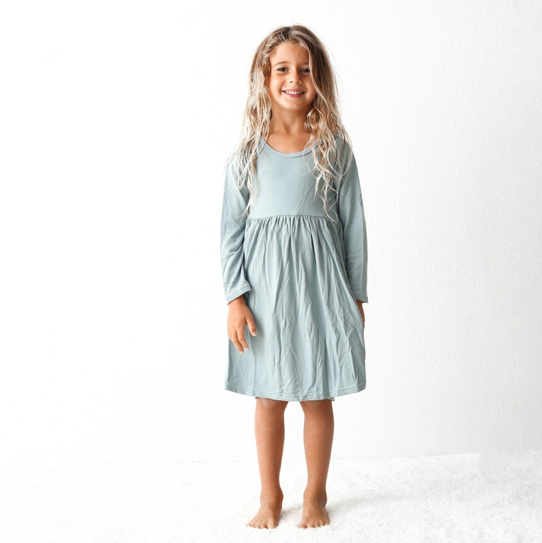 Slate grey long sleeve dress on a young blond child model