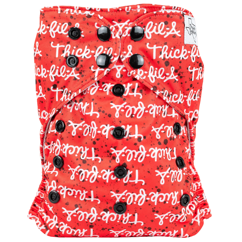 Slim fit AIO cloth diaper with red and white text design, featuring black snaps.