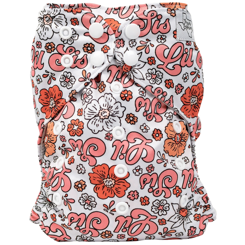 Slim Fit AIO Cloth Diaper with floral and text pattern, snap closures, lightweight athletic wicking jersey material.
