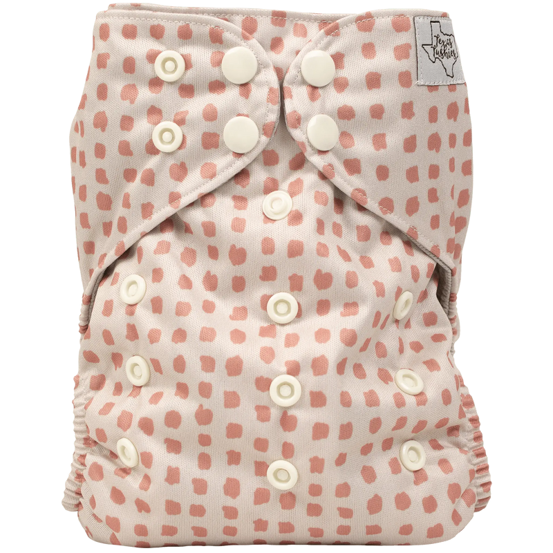 Slim fit AIO cloth diaper with pink dot pattern and adjustable snaps for 8-40lbs babies.