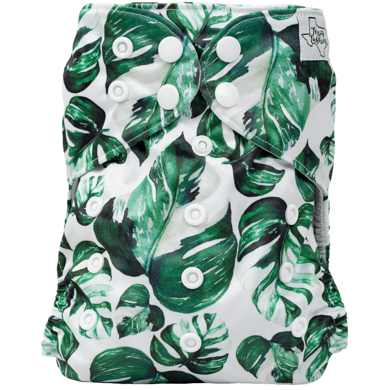 Slim Fit AIO Cloth Diaper with green leaf print, adjustable snaps, water-resistant recycled material.