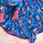 Baby swaddle blanket with a soccer ball pattern, spread flat and square