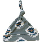 Newborn knot hat with a Southwest Aztec pattern in soft ribbed bamboo fabric.