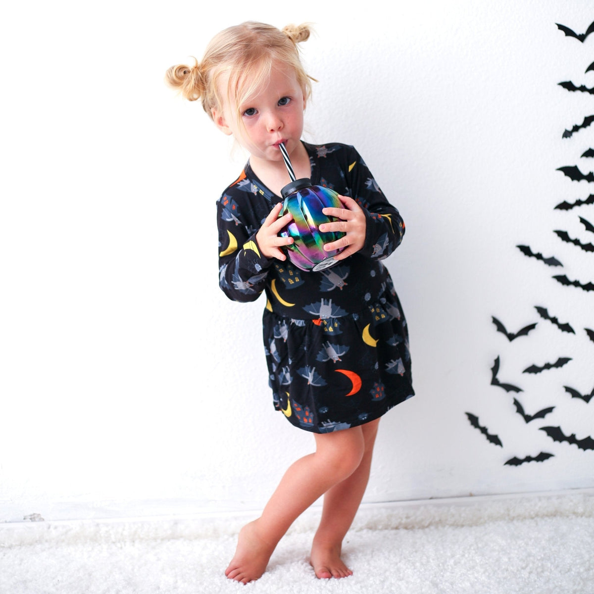 Long-sleeve baby bodysuit dress with a colorful Halloween Spooky Nights print and snap closure at the inseam.
