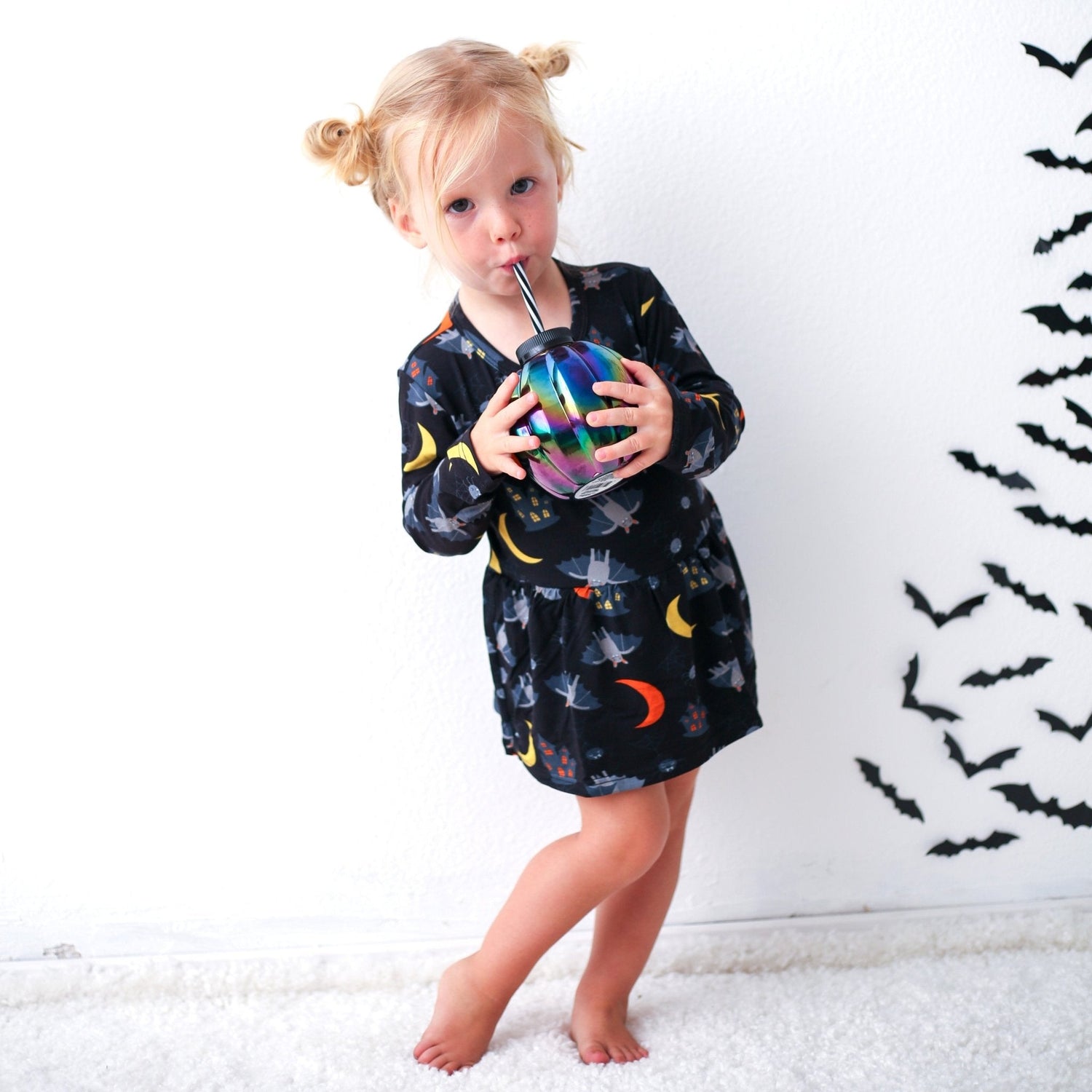 Long-sleeve baby bodysuit dress with a colorful Halloween Spooky Nights print and snap closure at the inseam.