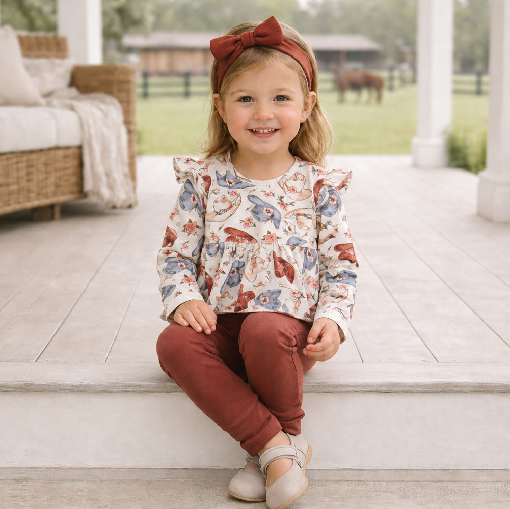 Two-piece baby set with a Wildflower Rodeo print ruffle-shoulder long-sleeve top and matching rib leggings.