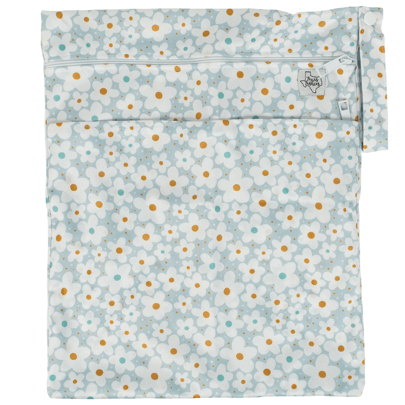 Texas Tushies Wet/Dry Bag with floral pattern, two compartments, and strap.