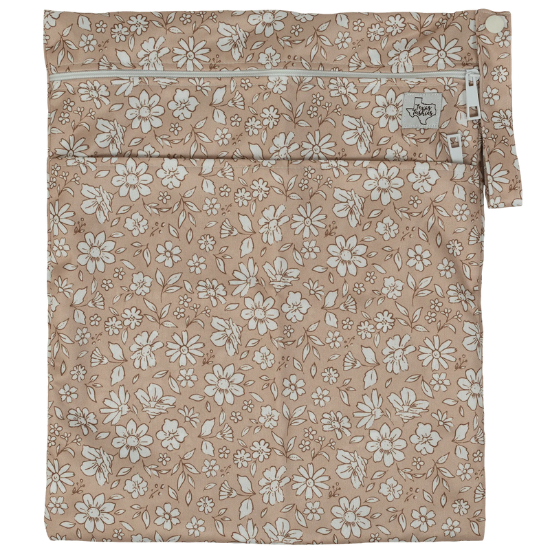 Texas Tushies Wet/Dry Bag with floral print, durable dual compartments, and double zipper design.