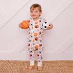 Baby coverall in orange with basketball print, cuffed ankles, and a front dual zipper.