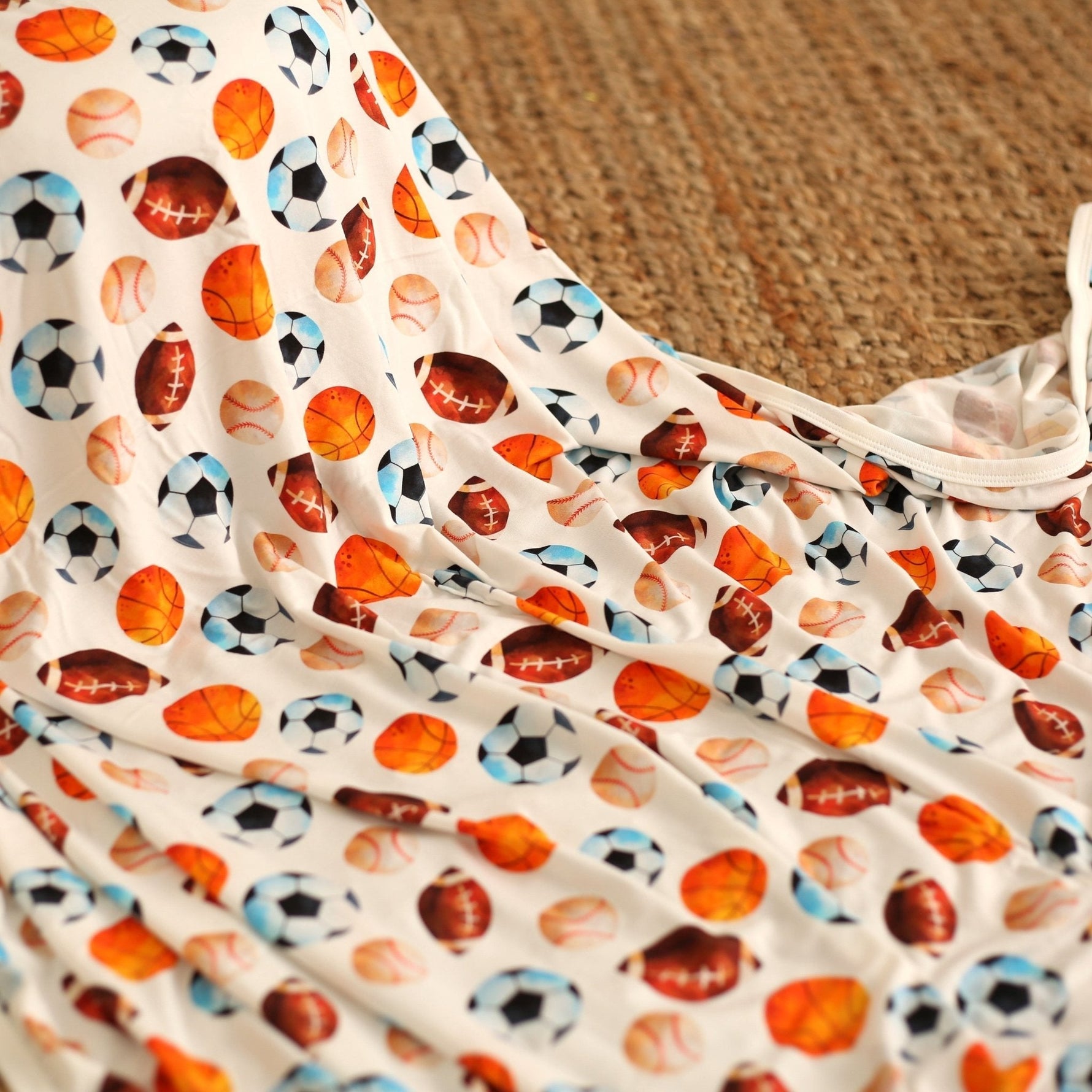 Square baby swaddle blanket with a sports-themed star player pattern