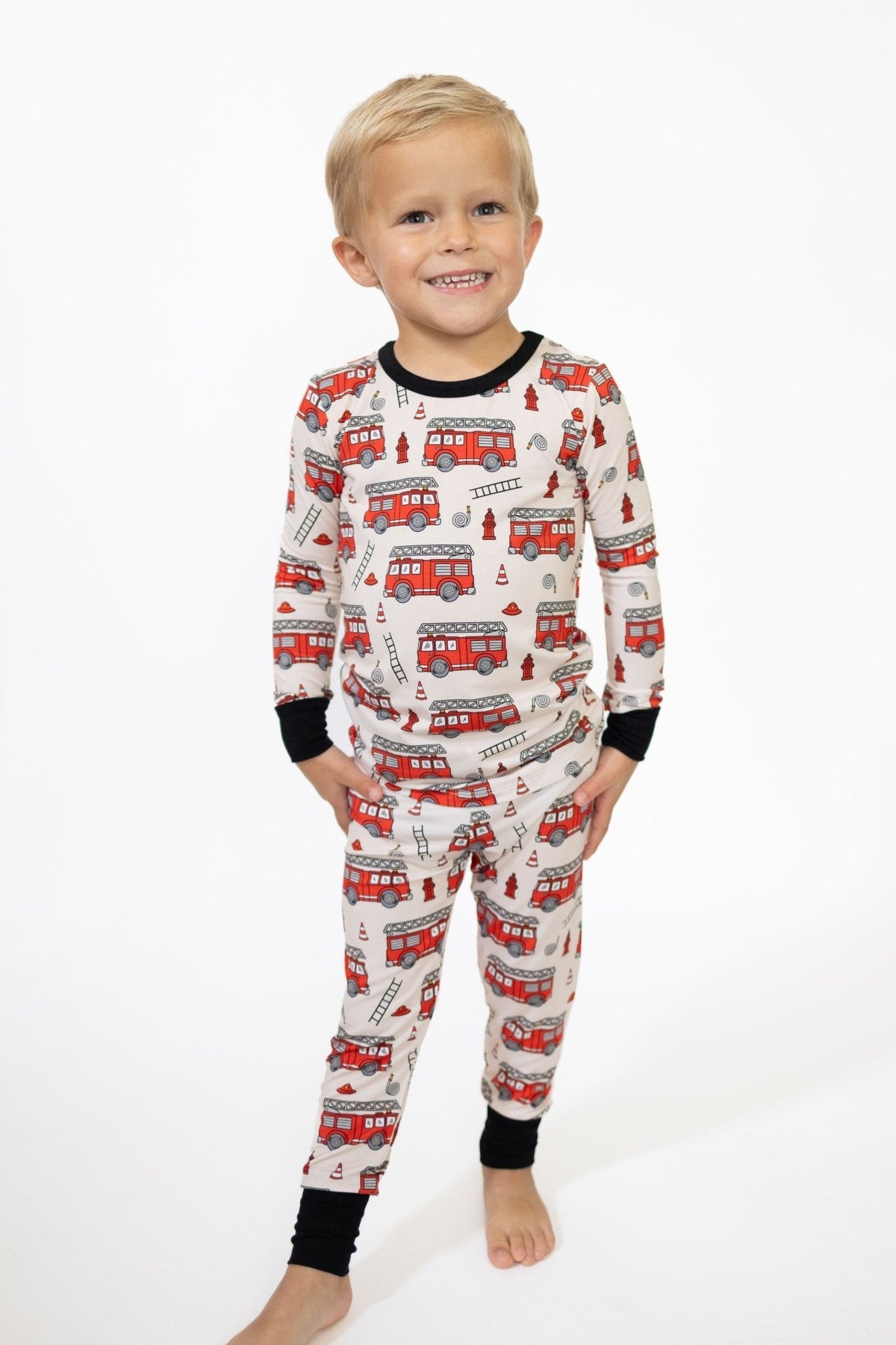 Toddler two-piece long-sleeve pajama set in a bold firetruck-inspired print with long sleeves and pants.