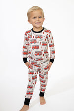 Toddler two-piece long-sleeve pajama set in a bold firetruck-inspired print with long sleeves and pants.