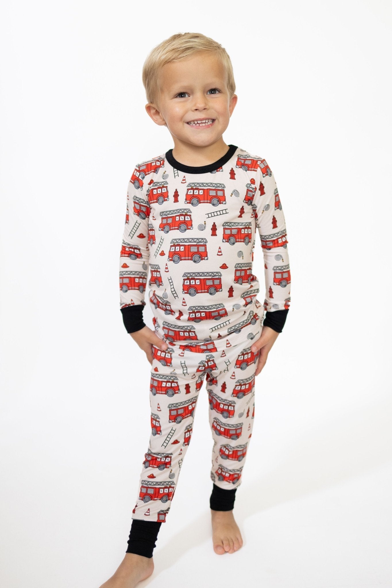 Toddler two-piece long-sleeve pajama set in a bold firetruck-inspired print with long sleeves and pants.