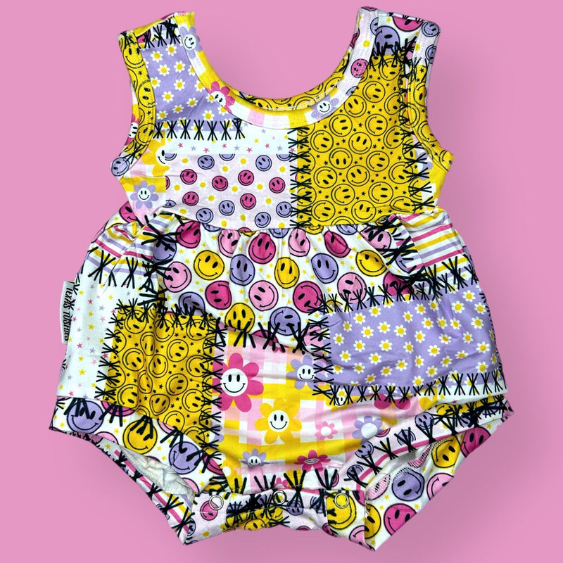 Summer Boxy Romper with colorful playful print on a pink background.