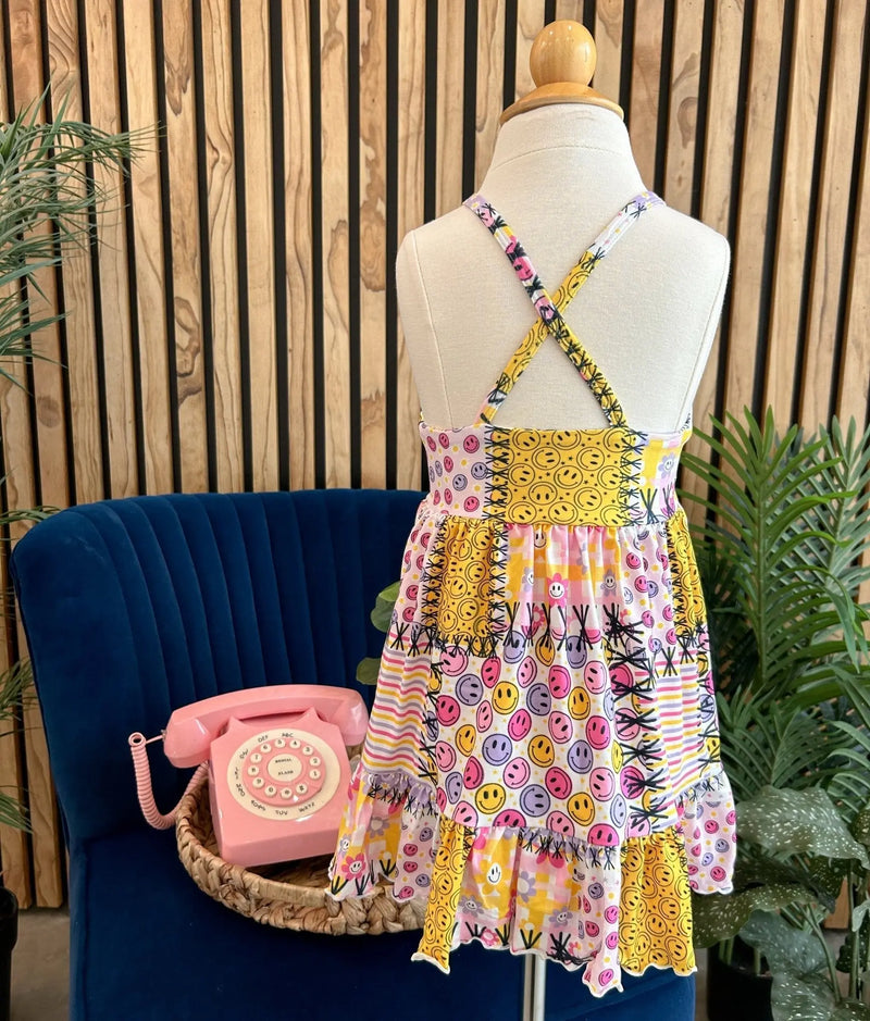 Summer Ruffle Dress with vibrant patterns displayed on a mannequin in a cozy indoor setting.