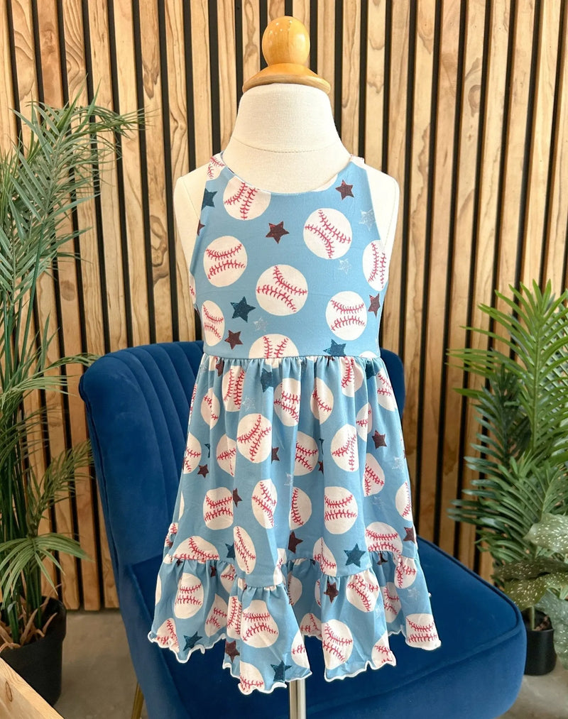 Summer Ruffle Dress with baseball pattern displayed on mannequin in a stylish room setting.
