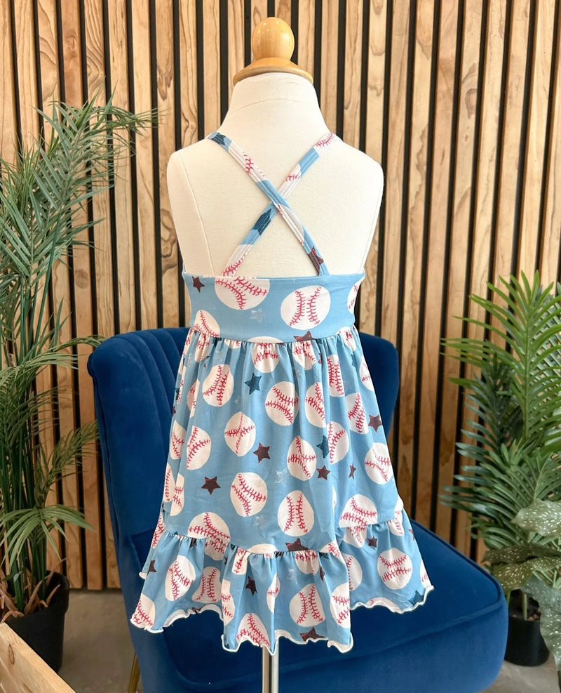 Summer Ruffle Dress with baseball print and cross-back straps on a mannequin in a stylish setting.