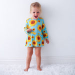 Bodysuit dress with sunflower print, long sleeves, and snap closure at the inseam