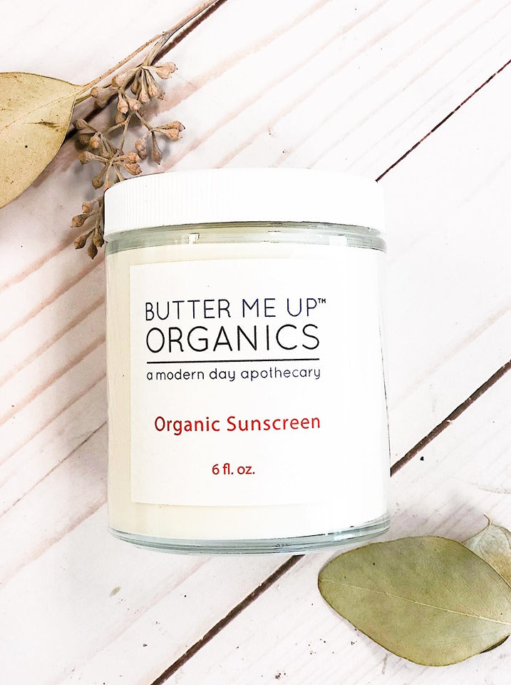 Natural organic sunscreen in a glass jar from Butter Me Up Organics, made with non-nano zinc oxide for effective sun protection.