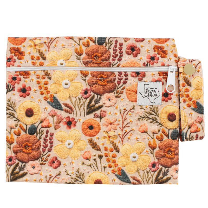 Sunset Embroidery mini wet bag with floral design, featuring a 6-inch handle.