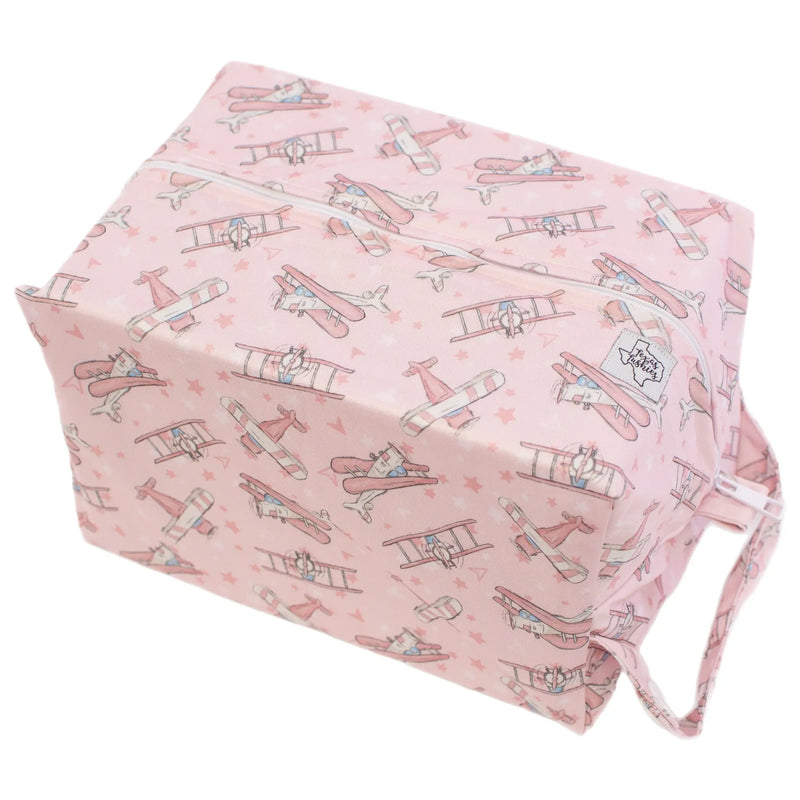 Take Flight - Pink - Pod, water-resistant, double-lined diaper bag with airplane design.