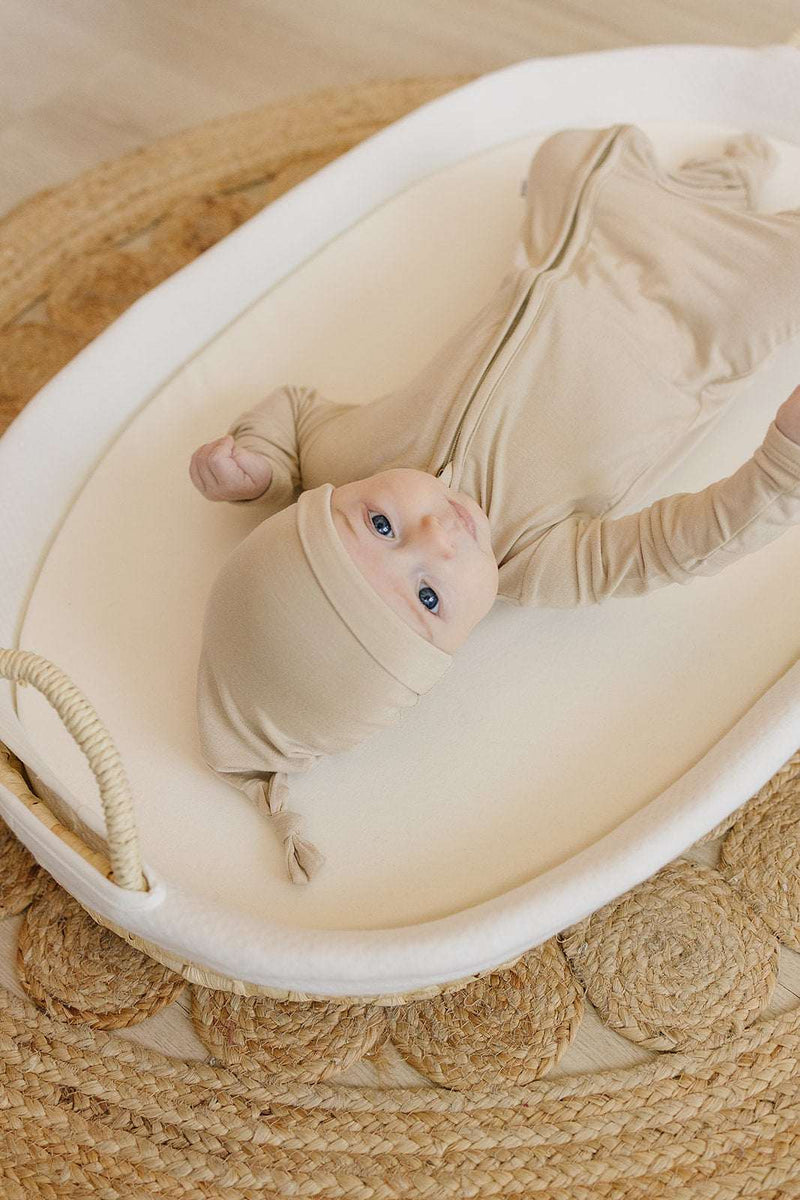 Super soft tan knot hat for newborns to 3 months, made from bamboo viscose and spandex, perfect for warmth and style.