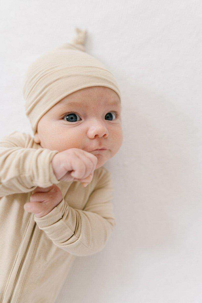 Tan knot hat for newborns, soft bamboo viscose, fits 0-3 months.