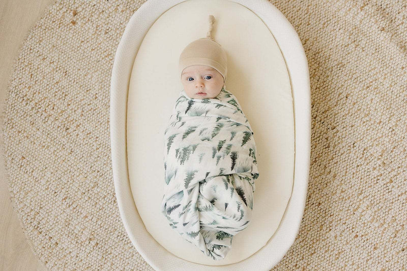 Tan knot hat for newborns to 3 months, soft viscose bamboo blend, comfortable baby accessory.