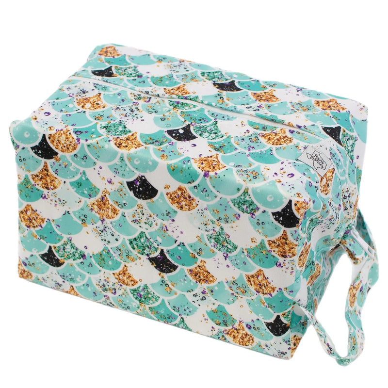 Teal Scales Pod water-resistant diaper bag with scale pattern.