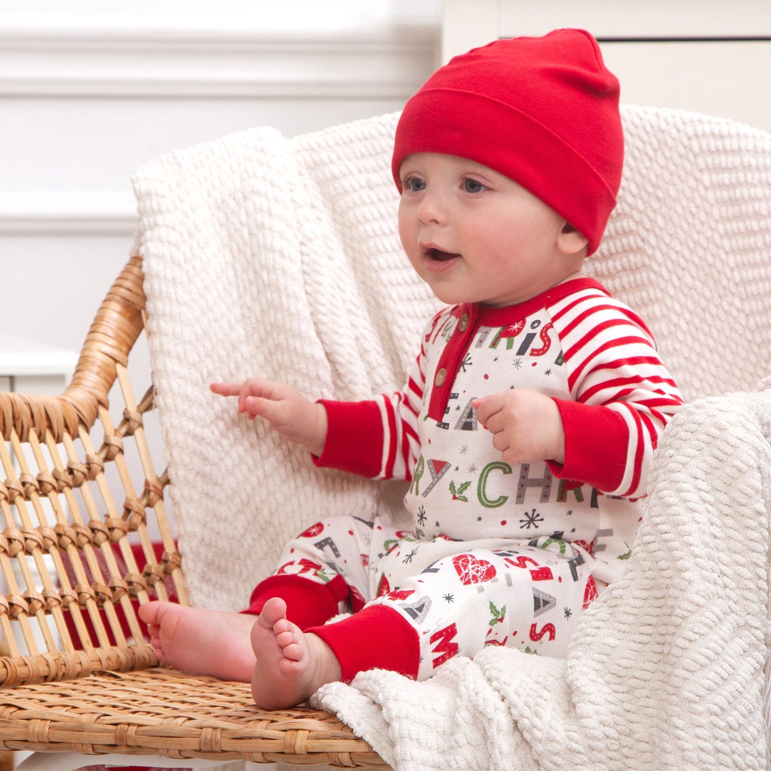 Baby romper with a holiday Peace Love Joy print and a snap henley neckline