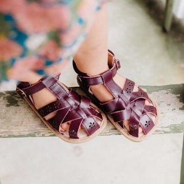 Closed toe toddler sandal with adjustable buckle strap across the top
